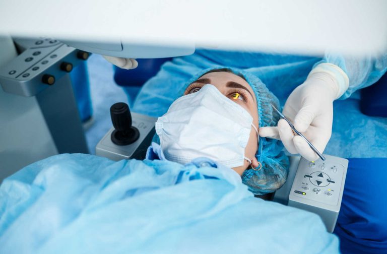 A patient lying on an operating table with an eye surgeon preparing for Lasik surgery.