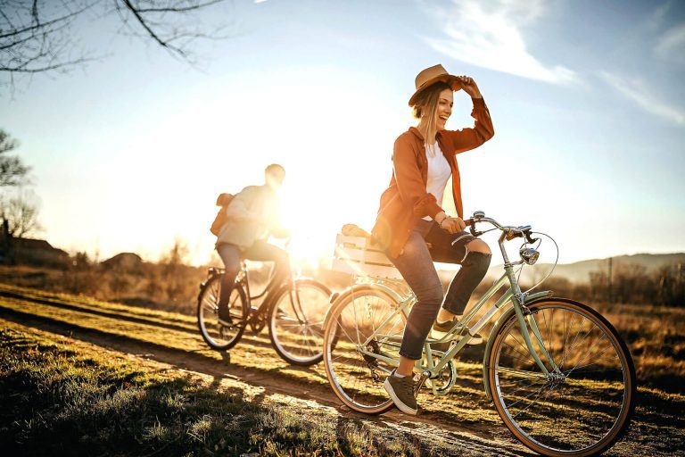 Person riding a bike with sunglasses after LASIK surgery.