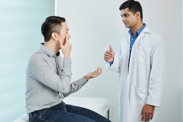 Patient and doctor discussing questions during a LASIK consultation.